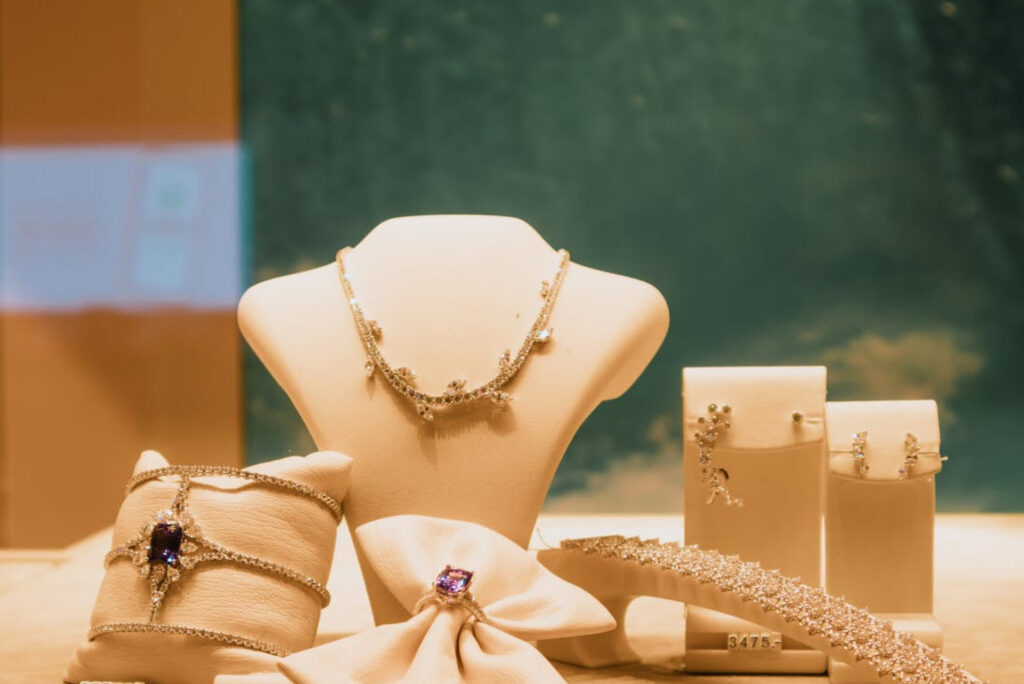 Fine jewelry collection displayed on warm ivory stands